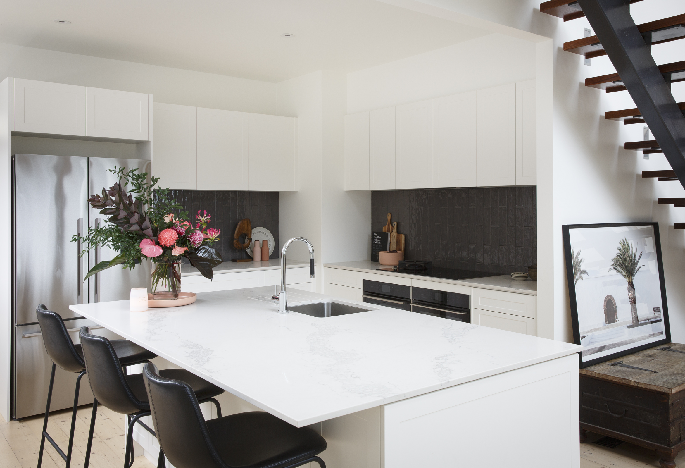 Stylish shaker style kitchen with white cabinetry and a large island with seating