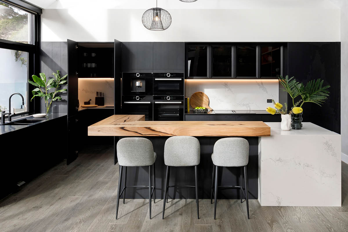 The Block Josh and Luke's kitchen design with a mix of dark woodgrain, timber and marble
