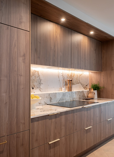 block24-h2 Contemporary Kinsman kitchen with light cabinetry and a large island bench