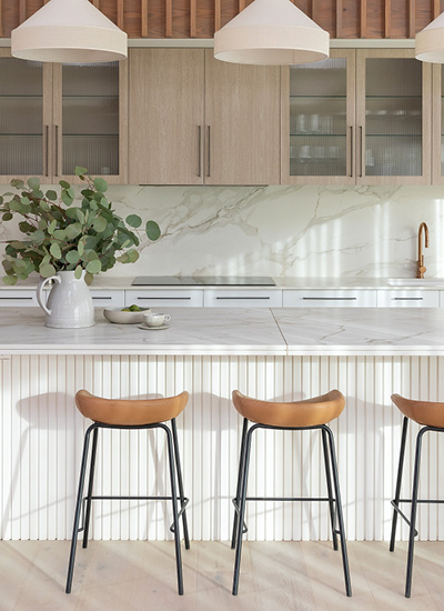 block24-h3 Kinsman kitchen featuring a curved stone island and timber cabinetry