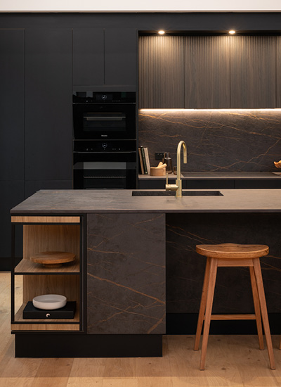 block24-h4 Dark Kinsman kitchen with black cabinetry and warm timber accents