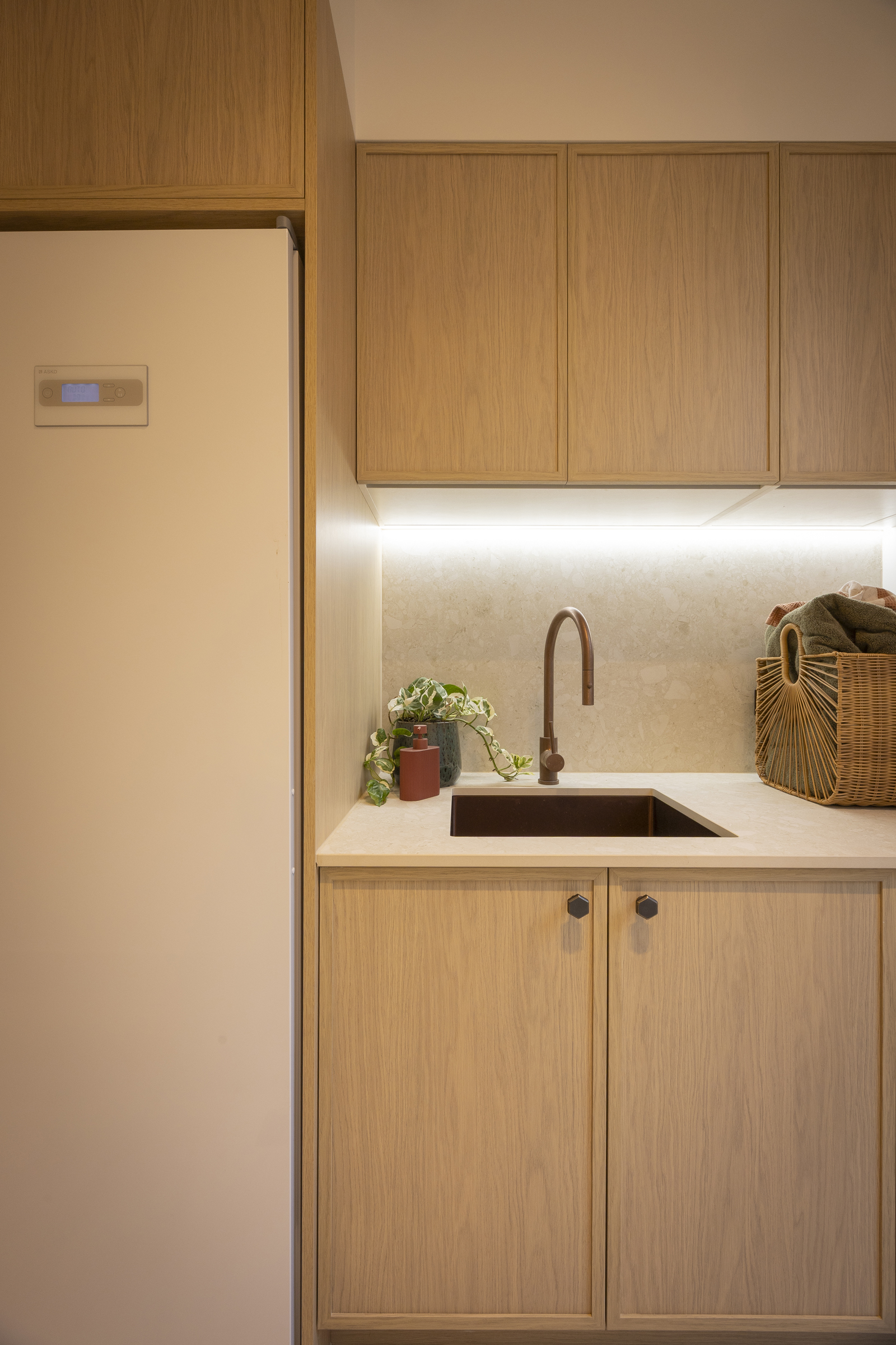 Close up of laundry with sink and tap and strip lighting