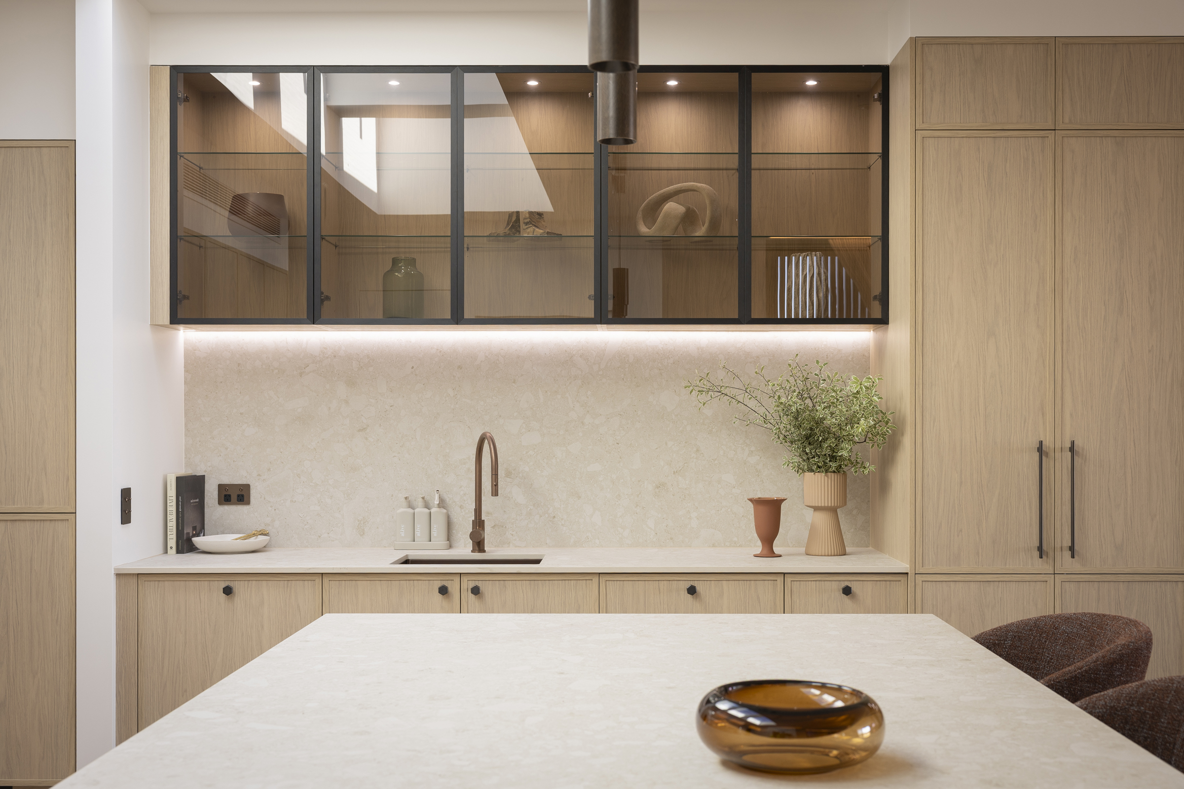 MA044 Adam & Jolene’s Kinsman kitchen with a matching Antique Bronze sink and tap, oak cabinetry and glass display cabinets