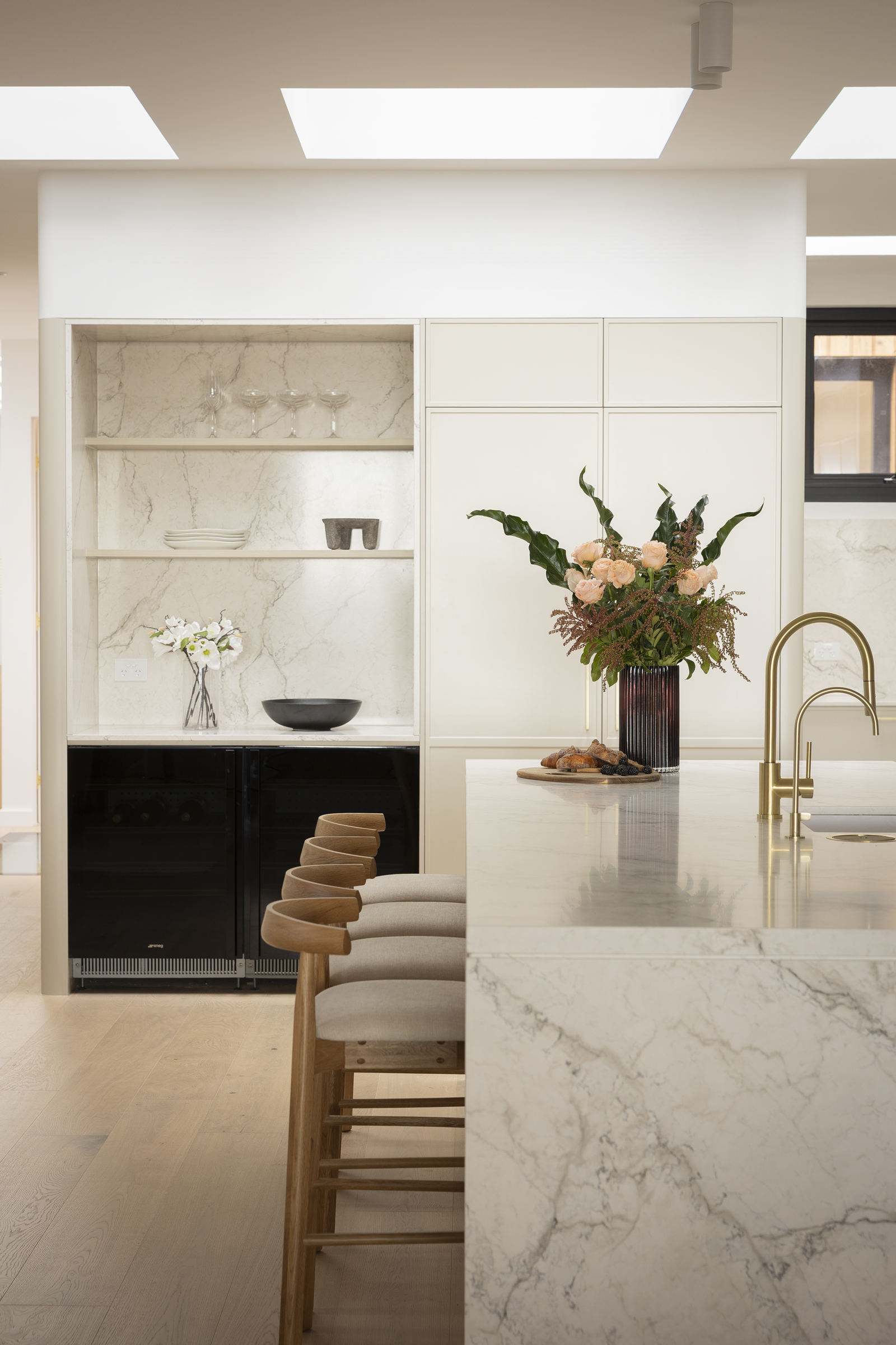 Eclos Wondr island benchtop with brass tapware and marble-look open shelving