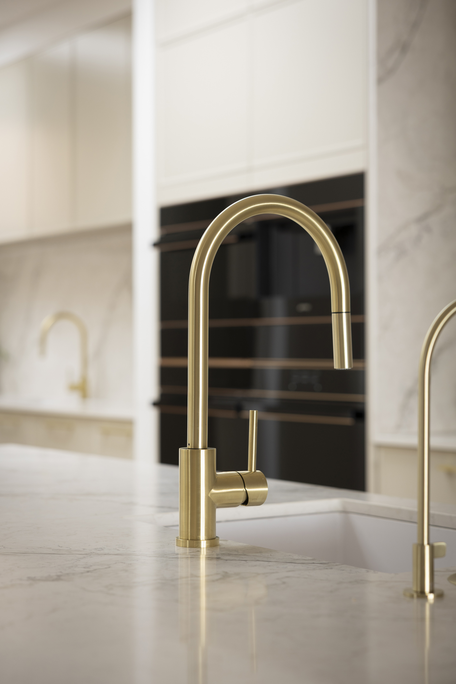 MA173 Brushed brass kitchen mixer and filter tap on a white stone benchtop in Chantel & Wyatt’s kitchen on The Block 2026