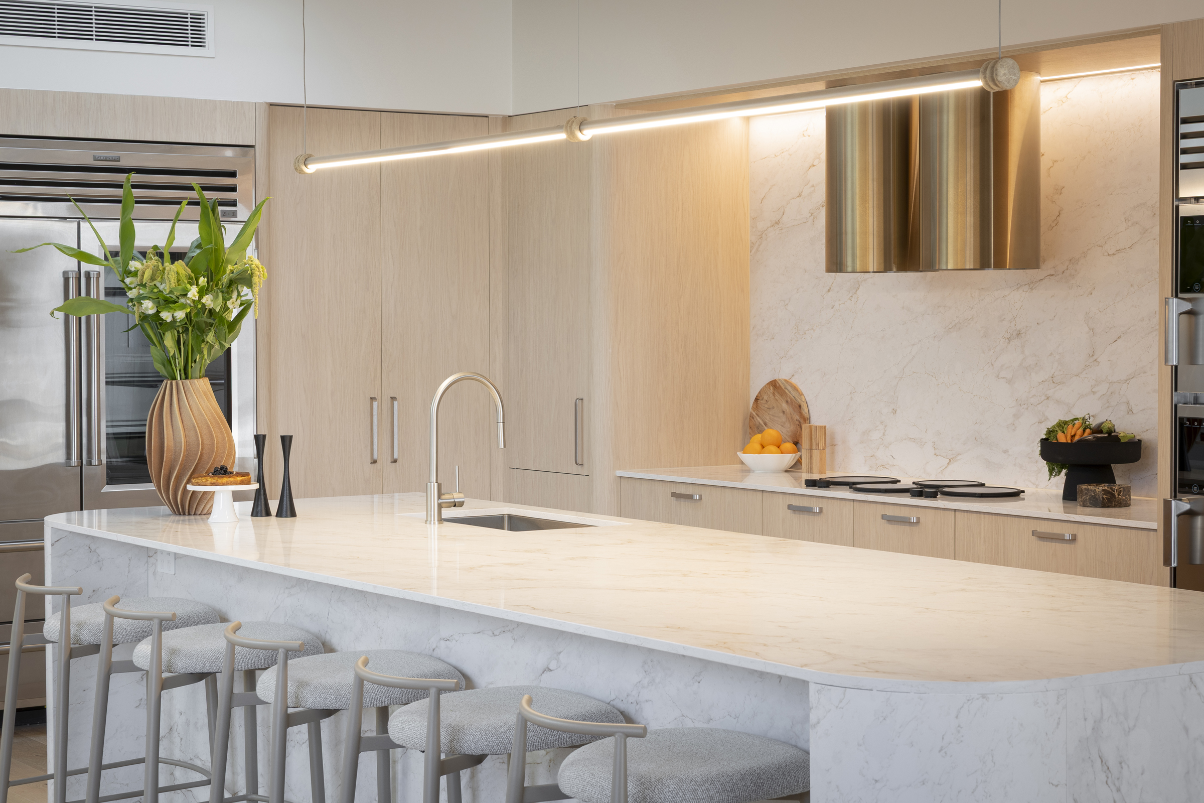 MA239 Curved stone kitchen island with a stainless steel pull-out mixer in Courtney & Sev’s Kinsman kitchen on The Block 2026