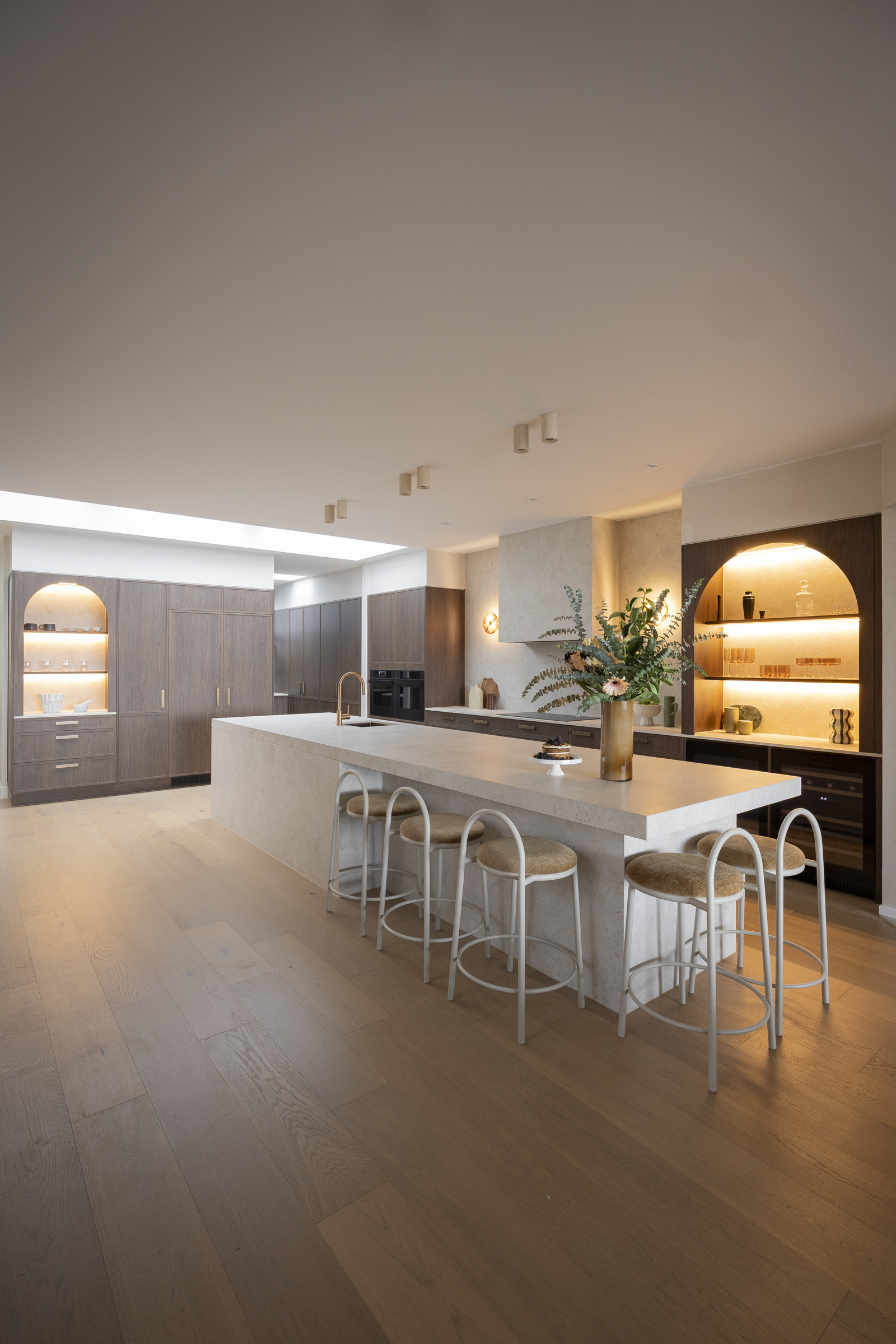 Lisa and Rosco’s kitchen with Dekton Sabbia island, rosewood oak cabinetry and arched shelving
